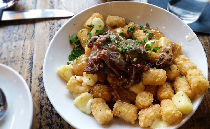 poutine tator tots topped with braised short rib, cheese curds and gravy